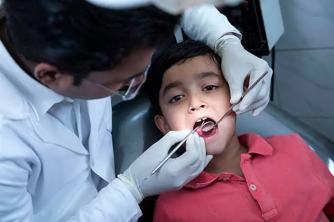 Child receiving a gentle dental check-up from a pediatric dentist at Gold's Dental Clinic